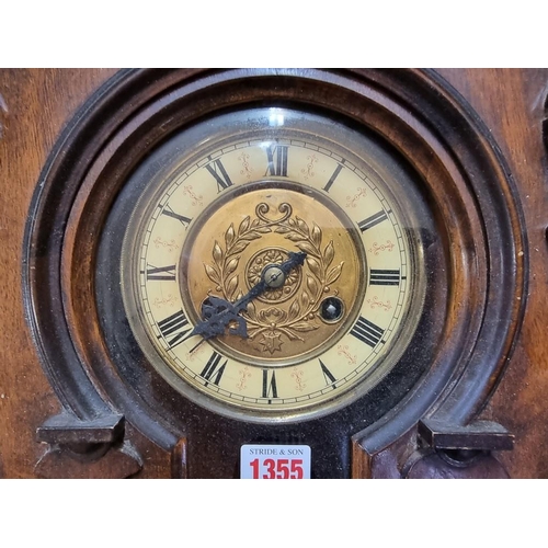 1355 - An antique walnut Vienna style wall clock, spring driven, 92cm high, with pendulum.