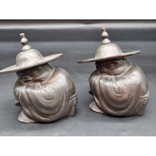 1360 - Two Japanese bronze crouching figures, with straw hat, 14.5cm high.  