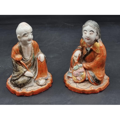 1361 - A pair of Japanese Kutani porcelain seated figures, each inscribed to base, 11cm high; together with... 