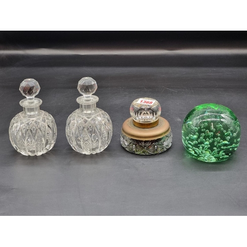 1368 - A pair of cut glass inkwells and stoppers, 14cm high; together with a green glass dump paperweight, ... 