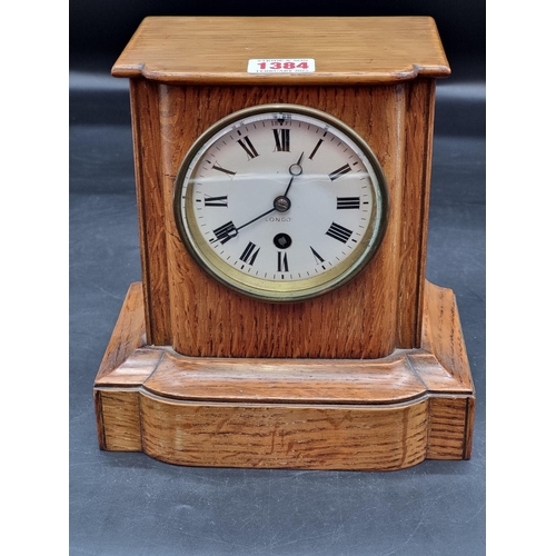 1384 - A late Victorian oak mantel clock, 25.5cm high, with pendulum.