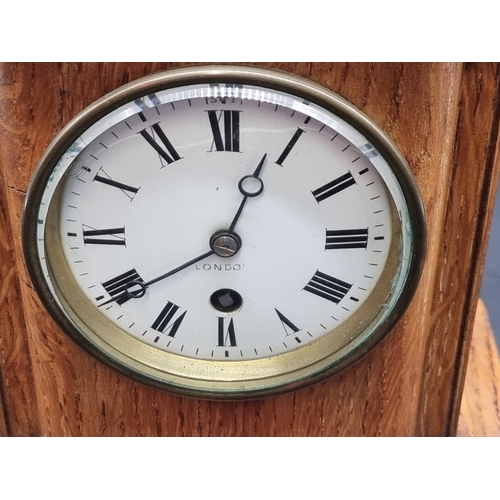 1384 - A late Victorian oak mantel clock, 25.5cm high, with pendulum.