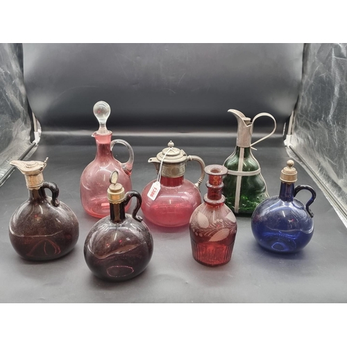 1386 - A collection of coloured glass jugs, ewers and decanters, largest 28.5cm high. ... 