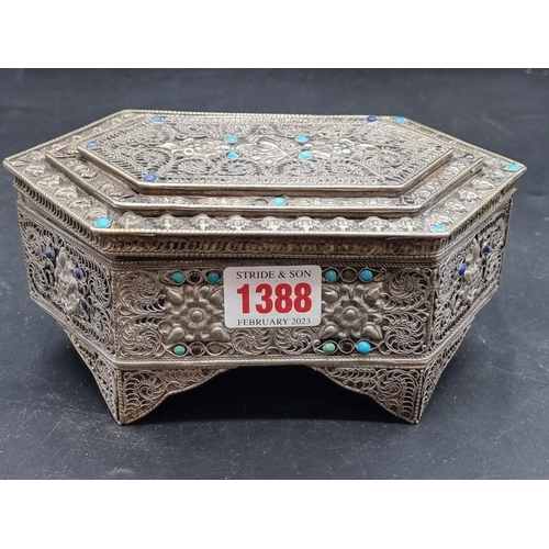 1388 - A filigree metal casket, with turquoise cabochon decoration, 18cm wide. 