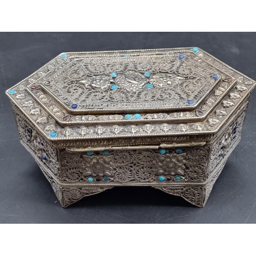 1388 - A filigree metal casket, with turquoise cabochon decoration, 18cm wide. 