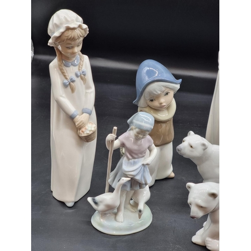 1389 - Two Lladro polar bears, largest 9.5cm high; together with seven other similar figures, largest 27cm ... 