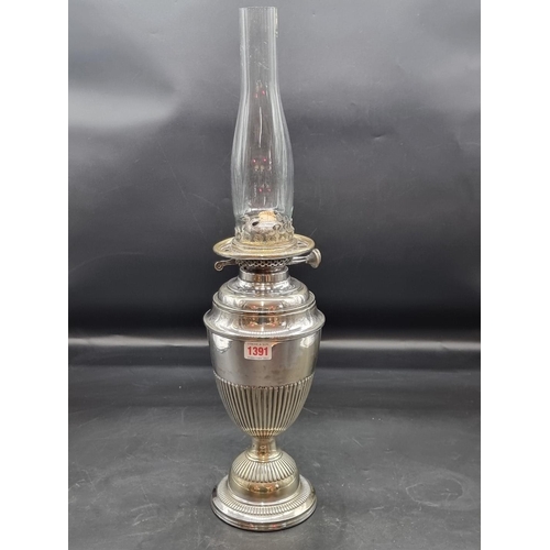 1391 - An electroplated oil lamp, height excluding chimney 37cm, (s.d.).