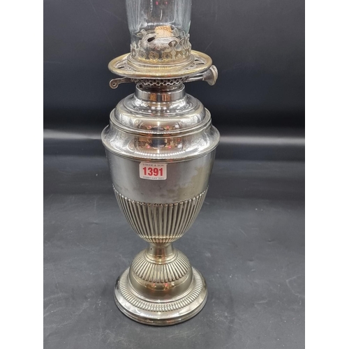 1391 - An electroplated oil lamp, height excluding chimney 37cm, (s.d.).