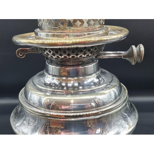 1391 - An electroplated oil lamp, height excluding chimney 37cm, (s.d.).