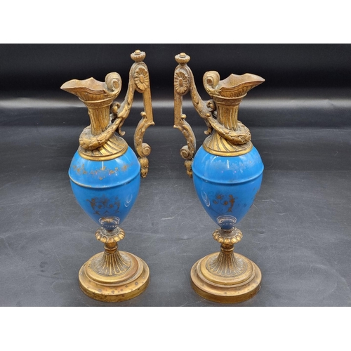 1400 - A pair of Sevres style gilt brass mounted ewers, 31cm high.