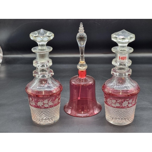 1401 - A good pair of cranberry flashed cut glass decanters and stoppers, 30.5cm high; together with a cran... 