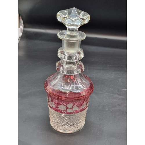 1401 - A good pair of cranberry flashed cut glass decanters and stoppers, 30.5cm high; together with a cran... 