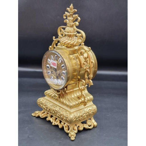 1425 - A brass mantel clock, with enamel chapter ring, 41.5cm high, with pendulum and winding key.&nbs... 