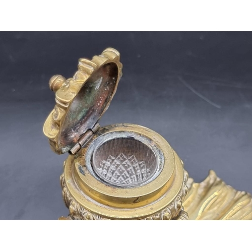 1451 - A rococo style brass dolphin and shell inkwell, 13.5cm high.