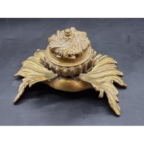 1451 - A rococo style brass dolphin and shell inkwell, 13.5cm high.