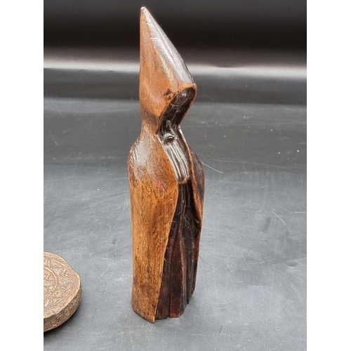 1452 - A carved beechwood hooded figure, possibly a Belsnickel or superstitious figure, 24.5cm high; togeth... 