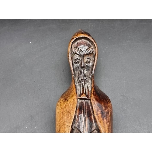 1452 - A carved beechwood hooded figure, possibly a Belsnickel or superstitious figure, 24.5cm high; togeth... 