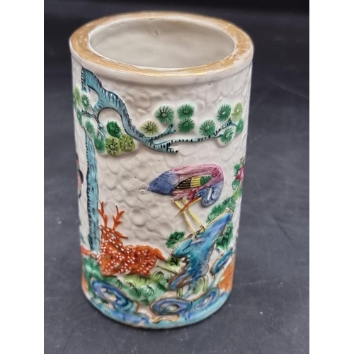 1453 - A Chinese famille rose sleeve vase or brush pot, late 19th century, relief decorated on a textured g... 