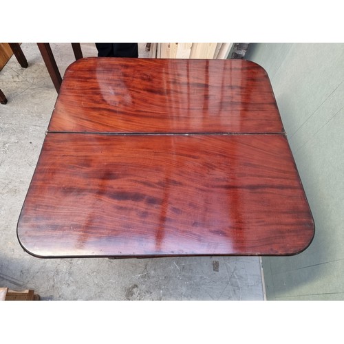 1628 - A George IV mahogany card table, 88cm wide. (break to leg).