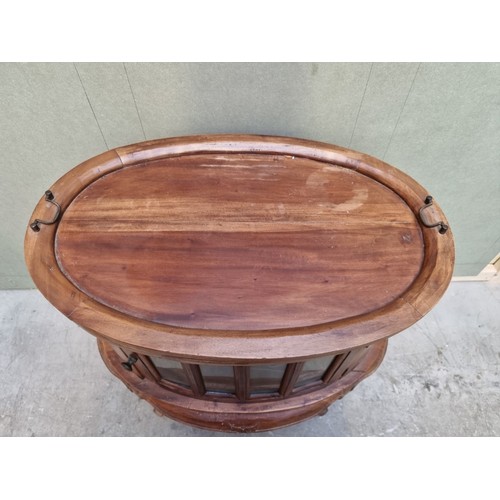 1617 - An Eastern hardwood oval tray top display cabinet, 81cm wide.