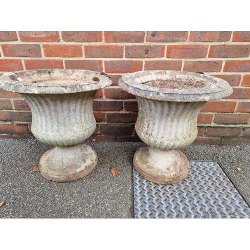 1624 - A pair of weathered composition stone urns, 40cm diameter.