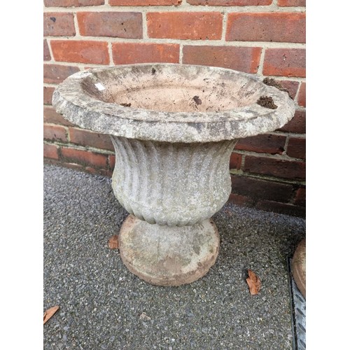 1624 - A pair of weathered composition stone urns, 40cm diameter.