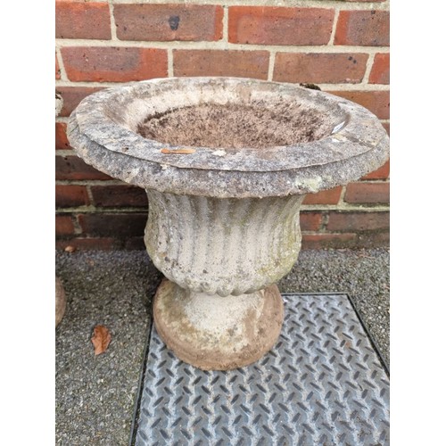 1624 - A pair of weathered composition stone urns, 40cm diameter.