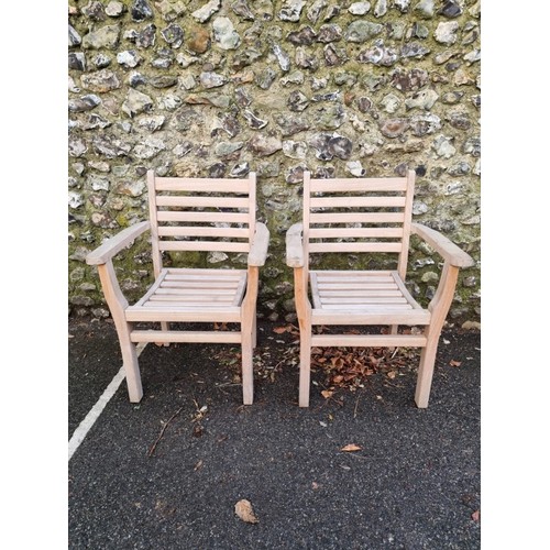 1645 - A pair of teak garden armchairs, labelled 'Lindsey', 64cm wide.