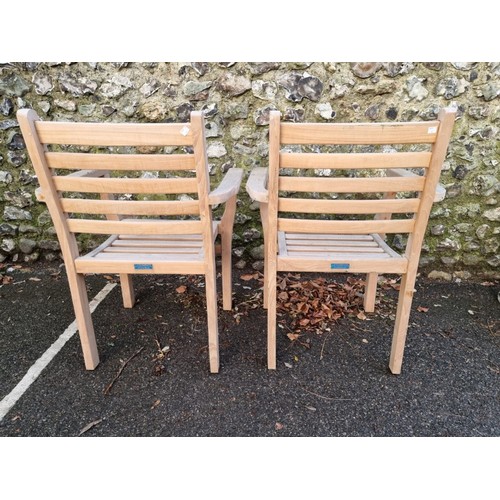 1645 - A pair of teak garden armchairs, labelled 'Lindsey', 64cm wide.