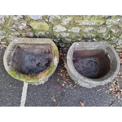 1653 - A pair of composition stone side planters, with floral decoration, 46cm diameter.