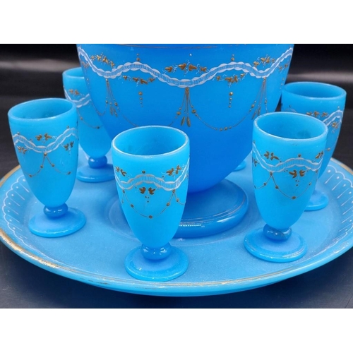 1466 - A late 19th century opaque blue glass punch set, comprising: a bowl and cover, 29.5cm high; stand; l... 