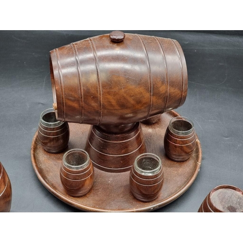 1467 - A treen spirit barrel, on integral tray base, with six tot glasses; together with a matching graduat... 