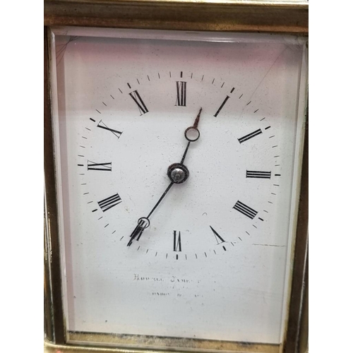 1473 - An antique brass carriage clock, the enamel dial indistinctly inscribed 'Howell James & Co...', ... 