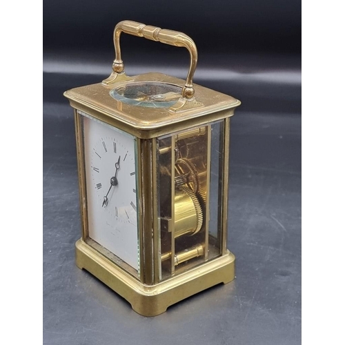 1473 - An antique brass carriage clock, the enamel dial indistinctly inscribed 'Howell James & Co...', ... 