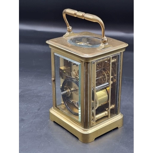 1473 - An antique brass carriage clock, the enamel dial indistinctly inscribed 'Howell James & Co...', ... 