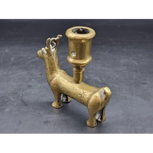 1476 - An antique brass zoomorphic candlestick, possibly Mediaeval, 11.5cm high.