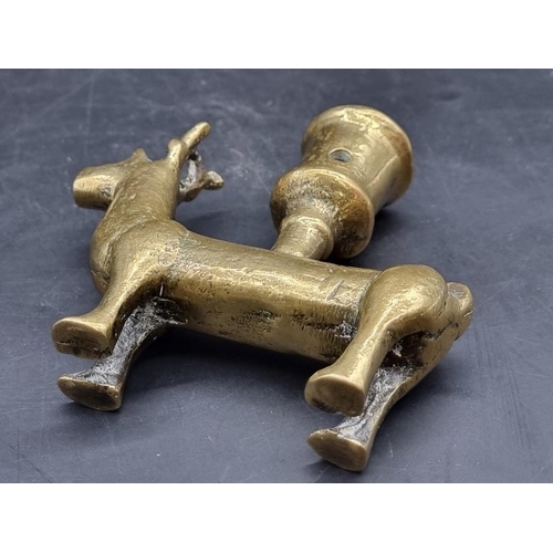 1476 - An antique brass zoomorphic candlestick, possibly Mediaeval, 11.5cm high.