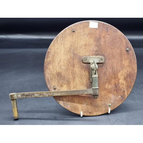 1477 - An antique mahogany and brass circular mirror, with ratchet mount to back, 26cm diameter.... 