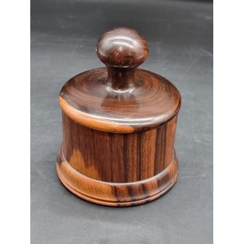 1478 - A lignum vitae circular box and cover, 10cm high. 