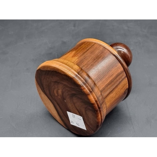 1478 - A lignum vitae circular box and cover, 10cm high. 