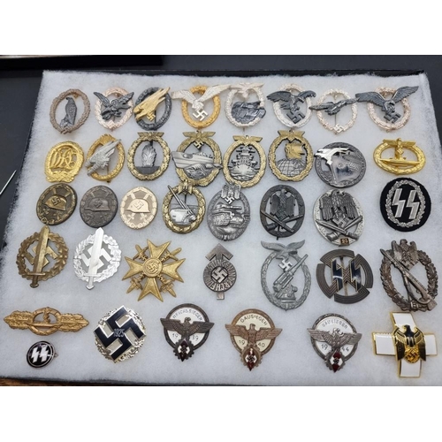 1488 - A collection of German Third Reich medals and badges, to include a large number of reproductions, in... 