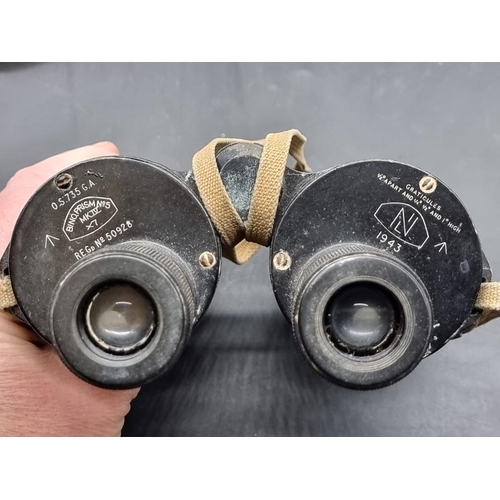 1498 - A pair of World War II military binoculars, in tan leather case. 