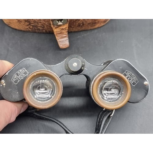 1499 - A pair of Carl Zeiss Delturis 8x24 binoculars, in tan leather case; together with a Baby Box camera,... 