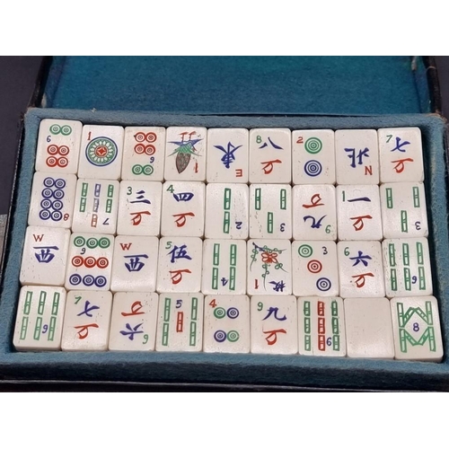 1501 - A vintage leather cased bone and bamboo mahjong set. 