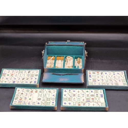 1501 - A vintage leather cased bone and bamboo mahjong set. 