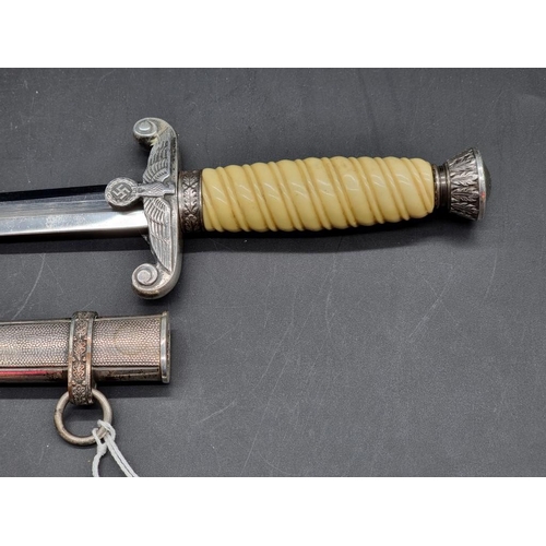 1552 - A German Third Reich army officers dagger and sheath, with white grip.