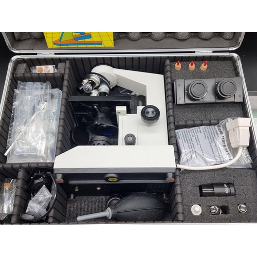 1575 - A Zenith Ultra 400 binocular microscope, cased, with a quantity of accompanying parts and slides, (a... 