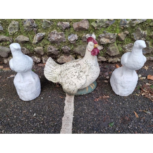 1652 - A pair of white painted composition stone doves, 32.5cm high; together with a similar chicken. (3)... 