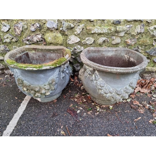 1653 - A pair of composition stone side planters, with floral decoration, 46cm diameter.