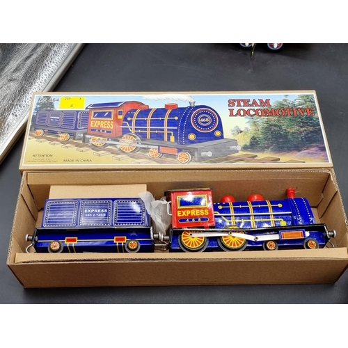 117 - Tinplate: a Chinese tinplate clockwork train; together with a bulldozer and others, all bo... 